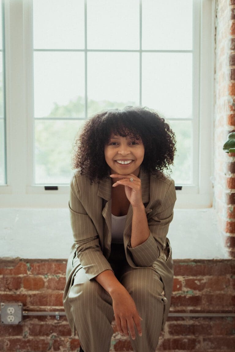 Brianna Briggs, Wake Forest SPS student sitting with her head propped on her hand.
